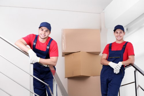 Team moving desks and filing units during an office removal in Loxford