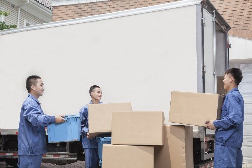 Local removals team handling furniture in a residential street