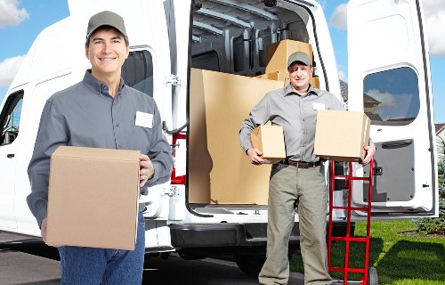 Professional movers loading household items for transport