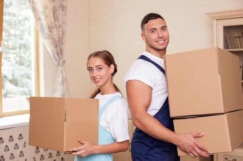 House moving team transporting furniture in Loxford