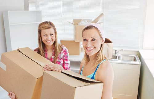 Business relocation team moving desks and storage in Loxford